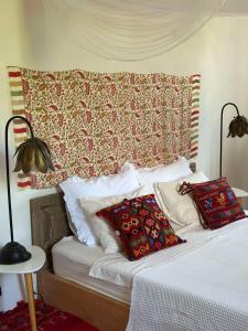 a bed with two pillows on it in a bedroom at Villa Bakola in Sívros