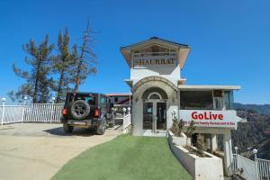 a jeep parked in front of a building at Hotel Shaurrat in Shimla