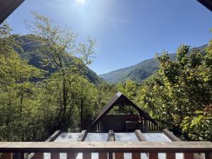 a cabin in the woods with mountains in the background at Edi Cottage in Bovec