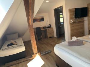 a attic room with a bed and a desk at Hotel Preyt -Self Check In- in Holtlander Nücke