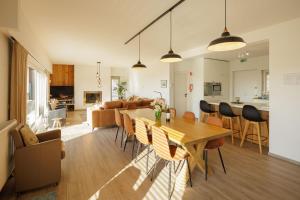 a living room and dining room with a table and chairs at Het Kastanjehuis in Orlitain