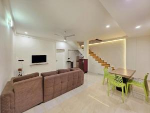 a living room with a couch and a table at JAGUAR VILLA II 3BHK II AC II POOL Il EMPYREAN STAY in Lonavala