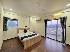 a bedroom with a bed and a large window at JAGUAR VILLA II 3BHK II AC II POOL Il EMPYREAN STAY in Lonavala +24 photos