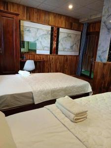 a hotel room with two beds and a chair at Hotel View Sông Phú Quốc in Phú Quốc