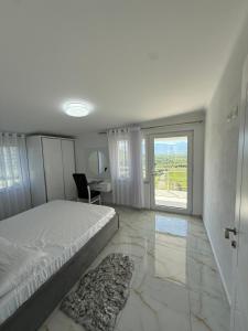 a bedroom with a bed and a large window at Panorama Helshan Hotel in Helshan