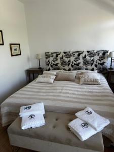 a bedroom with a large bed with towels on it at Casa Mimosa in Piana