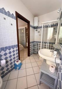 a bathroom with a sink and a toilet at Crisalide in La Maddalena