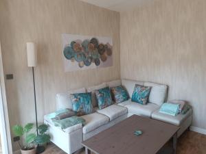 a living room with a couch and a table at Marmande in Marmande
