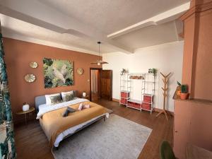 a bedroom with a large bed in a room at Capsule camelia un charme Montois in Mons