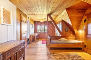 a bedroom with a bed and a wooden ceiling at Kleines Waldglück in Lenzkirch