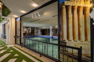 a balcony with a swimming pool in a building at Dolphin Continental Hotel in Kuwait