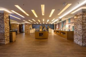 a lobby of a building with a bar in it at Dolphin Continental Hotel in Kuwait +57 photos