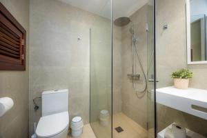 a bathroom with a shower and a toilet and a sink at Cala Figuera Apartment 1b in Cala Figuera +14 photos