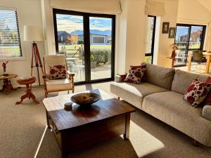 a living room with a couch and a coffee table at Alpine Abode in Wanaka