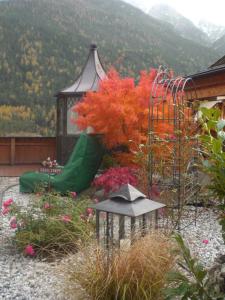 a garden with a gazebo and colorful flowers at Appartements Agnes in Fulpmes