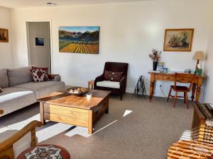 a living room with a couch and a coffee table at Alpine Abode in Wanaka