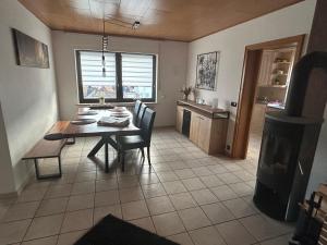 a kitchen and dining room with a table and chairs at Ferienhaus Windrödel in Herzhausen