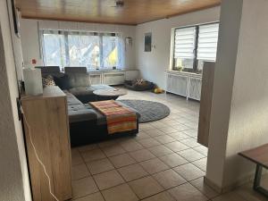a living room with a couch and a table at Ferienhaus Windrödel in Herzhausen