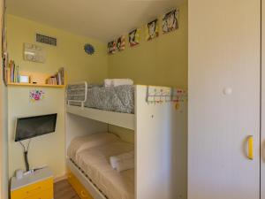 a small bedroom with bunk beds and a tv at EnjoyIseoLake - Blooming Lakefront in Fonteno