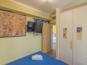 a room with a bed and a tv on a wall at EnjoyIseoLake - Blooming Lakefront in Fonteno