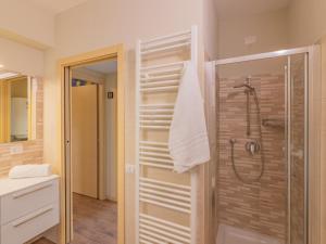 a bathroom with a shower with a glass door at EnjoyIseoLake - Blooming Lakefront in Fonteno +17 photos