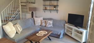 a living room with a couch and a table at Lilli's House in Kassiopi