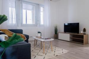 a living room with a tv and a coffee table at The Graoully's Cave - Hyper Centre in Metz