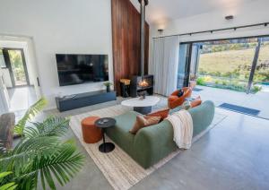 a living room with a couch and a fireplace at The Valley Lodge in Yallingup