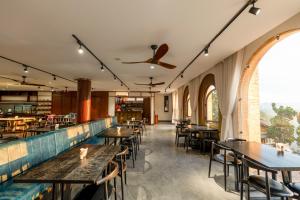an empty restaurant with wooden tables and chairs at Zen Valley Dalat in Da Lat