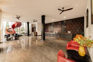 a living room with red furniture and a lobby at Zen Valley Dalat in Da Lat