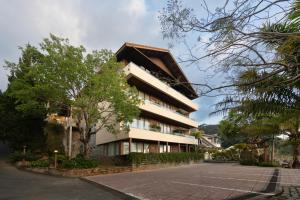 a building with a roof on the side of a street at Zen Valley Dalat in Da Lat