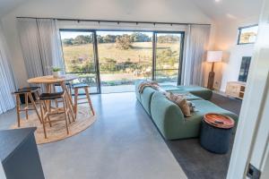 a living room with a couch and a table at The Valley Lodge in Yallingup