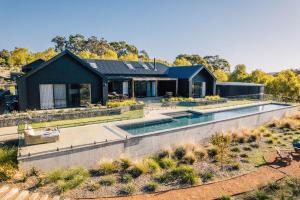 a house with a swimming pool in front of it at The Valley Lodge in Yallingup
