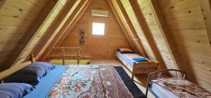 a room with two beds in a wooden cabin at Wooden Fairytale in Bihać