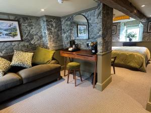 a bedroom with a bed and a desk in a room at The Unicorn, Ambleside in Ambleside