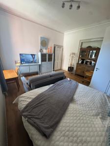 a bedroom with a bed and a couch at Elfenvilla in Erkelenz +5 photos