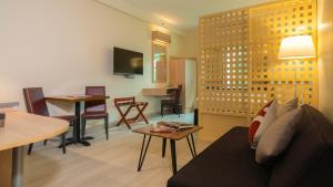 a living room with a couch and a table at Microtel by Wyndham UP Technohub in Manila