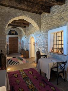 a room with a table and a stone wall at Claustrum di Colforcella in Cascia