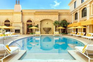 a swimming pool with chairs and a building at The St. Regis Atlanta in Atlanta