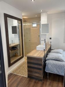 a bathroom with a sink and a mirror at T2 design climatisé au coeur de Divonne in Divonne-les-Bains
