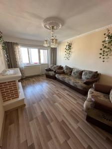 a large living room with couches and a chandelier at Perla Central Apartment in Zalău