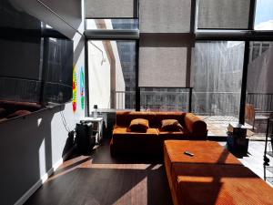 a living room with a couch and some windows at Duplex Close to HPU Waikiki Pool Terrace Laundry One and Half Bath for 15person in Honolulu