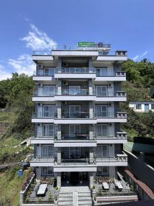 a tall white building with stairs in front of it at The Kagbeni Hotel in Pokhara