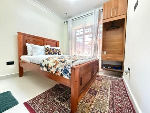 a bedroom with a bed with a window and a rug at Gono Retreat Four bedroom in Kisumu +22 photos