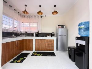 a kitchen with a sink and a refrigerator at Gono Retreat Four bedroom in Kisumu