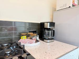 a kitchen with a counter with a coffee maker on it at Gono Retreat Four bedroom in Kisumu