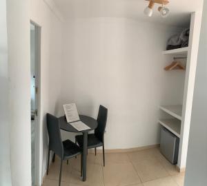 a small table with two chairs and a sign on it at Casa los Pinos Calpe Playa in Calpe