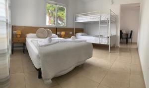 a bedroom with two beds and a bunk bed at Casa los Pinos Calpe Playa in Calpe +76 photos