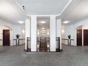 a lobby with white columns and a staircase in a building at smartments Hamburg Aussenalster in Hamburg