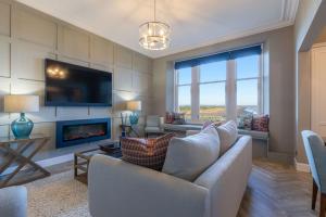 a living room with a couch and a fireplace at 20 Golf Place in St. Andrews
